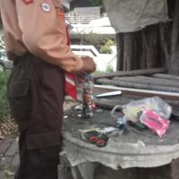 A scout packing plastic waste tightly into a used bottle
