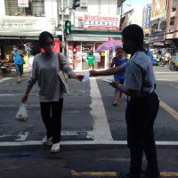 Rover Scout Reyes giving out informative Flyers to a pedestrian