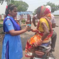 Serving water to the public waiting for the train to pass. 