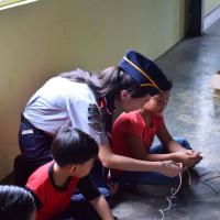 Teaching the children to tie a reef knot
