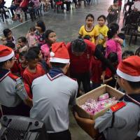 Distributing snack gift bags to the children