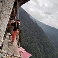 Scout and dessup collaborating for the white wash of monastery wall. 