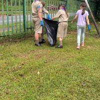 Picking up litter blown along the fence line