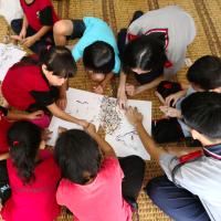 Sze Min and Dickson creating alphabet craft with the children