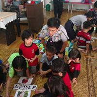 Gary teaching the children to spell
