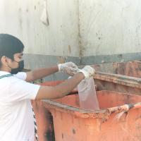 Puting Garbage in the dust bin.