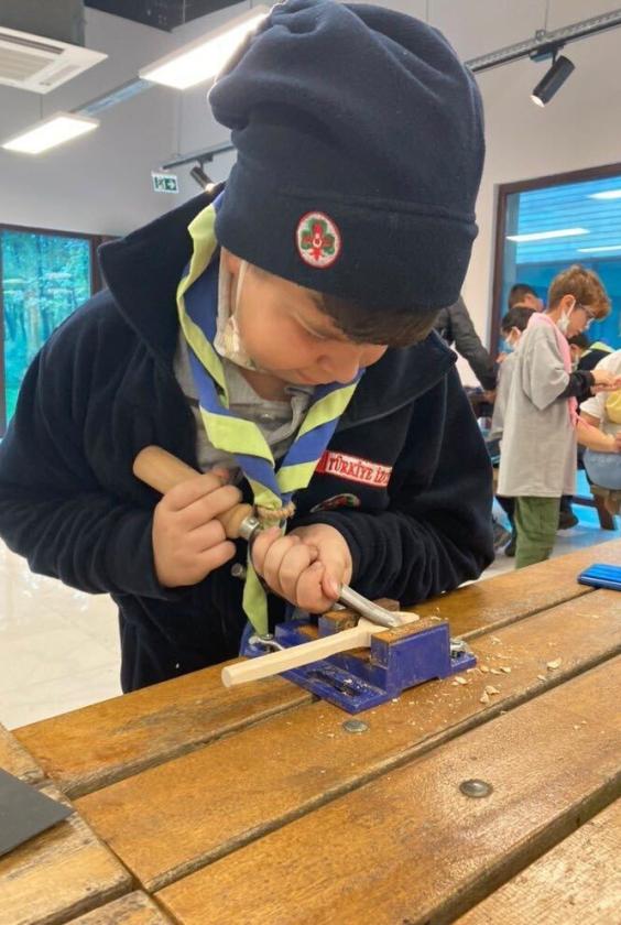 a scout doing some wood work