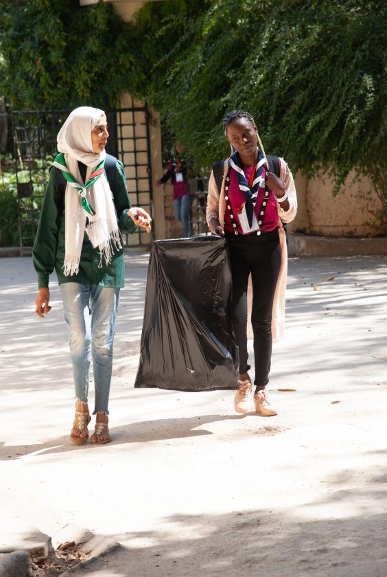2 scouts holding a garbage bag