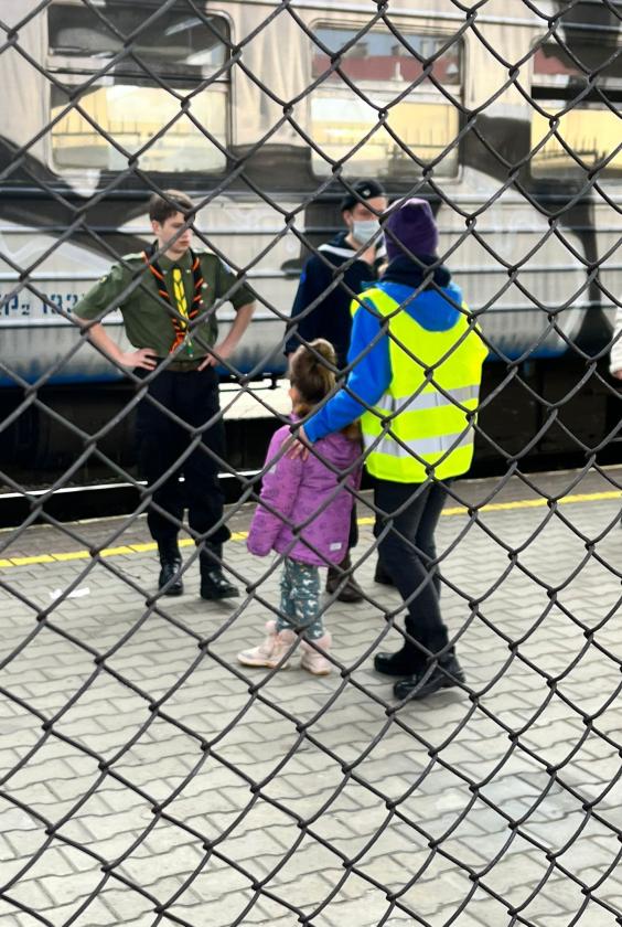 a scout talking to a child 