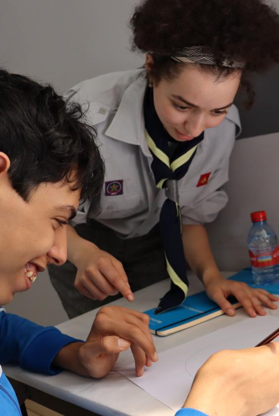 A sscout leader teaching a child