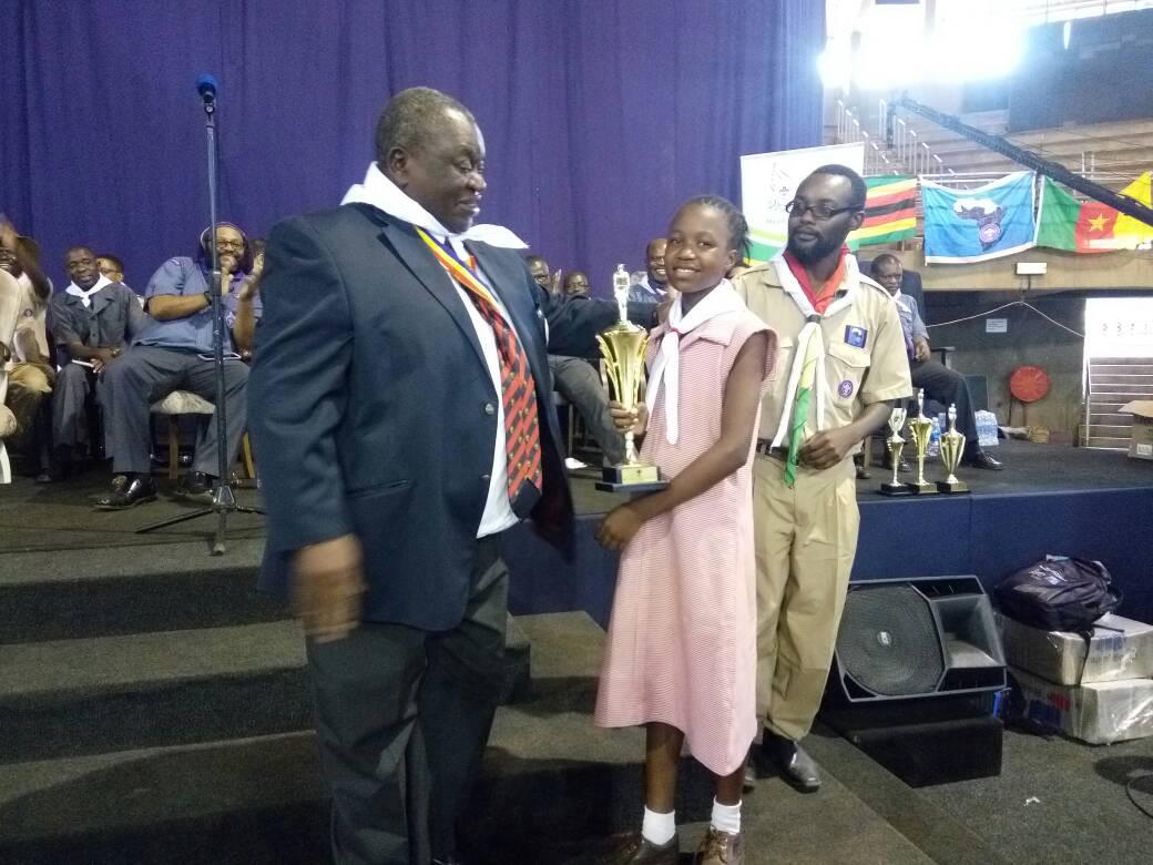 One of our very own scouts from Redcliff Primary School Midlands Province Zimbabwe is awarded for the best art presentation during the Africa Scouts day camp
