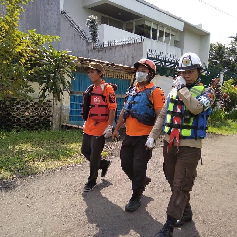 Members of Homeland Defense Special Unit and Rescue Teams Search for the Body of a Young Boy who Drowned in Ciliwung River