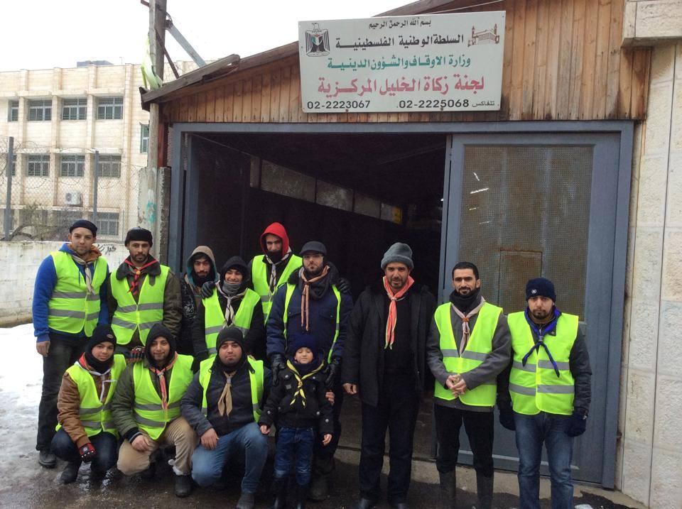 Hebron Scout Group In cooperation with Hebron Zakah committee in helping needy .
