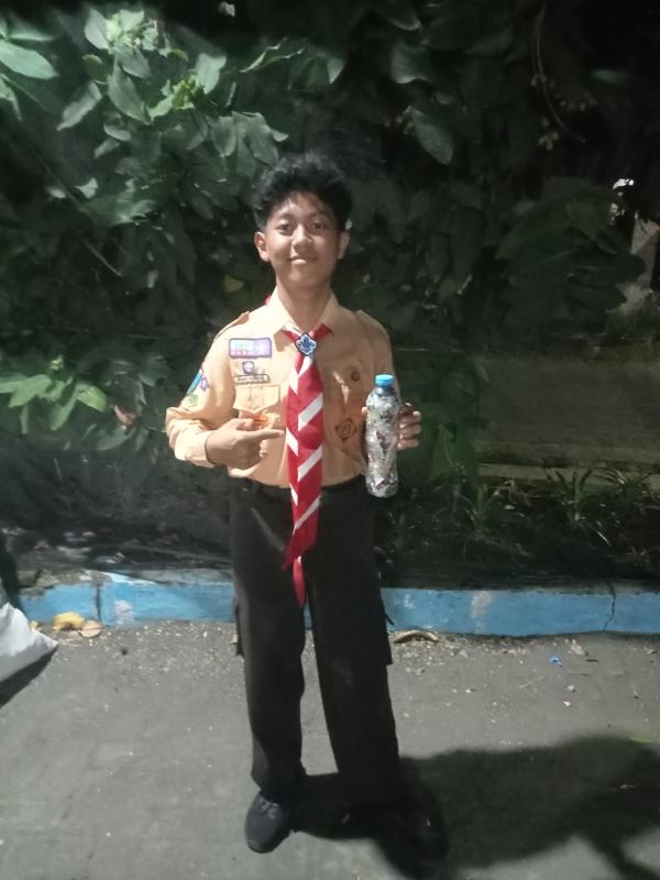 A scout holding his completed ecobrick
