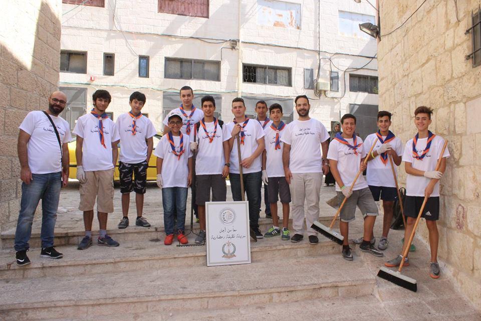 Scout members clean a historical monument 