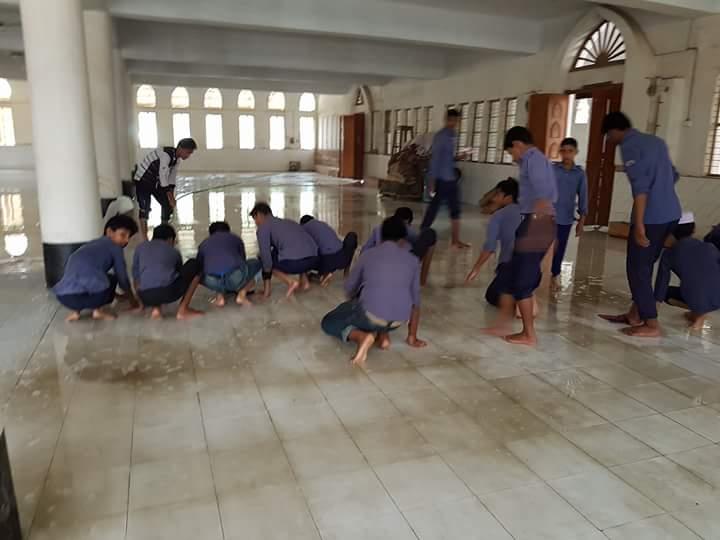 Washing the floor of a mosque by Scouts