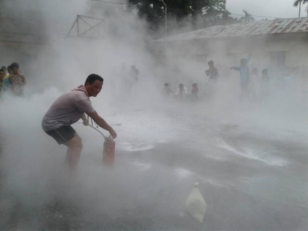 Demonstrating fire fighting techniques to scouts members...