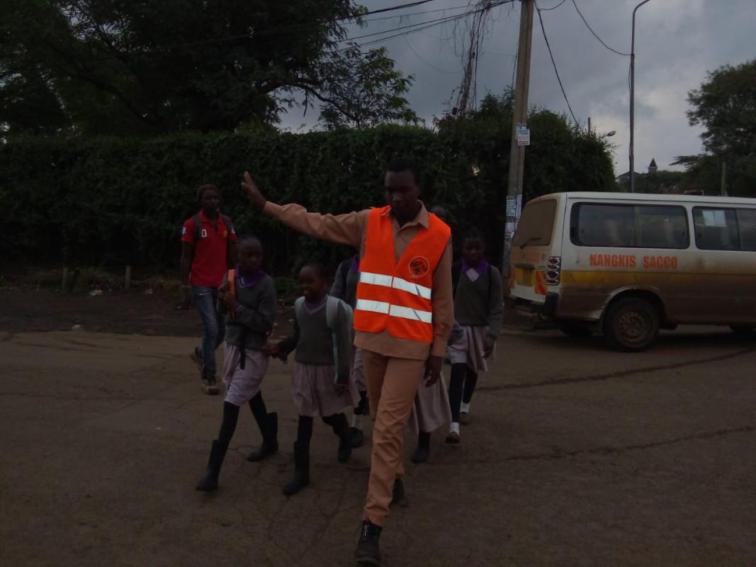 Kibra Rovers helping kids cross the road. 