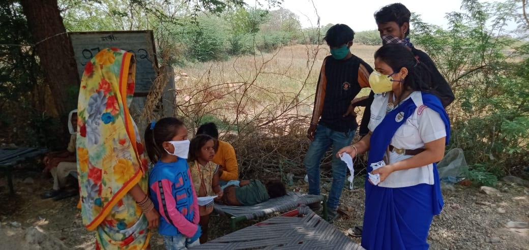 मास्क बाटते हुए स्काउट गाइड केप्टन जयलता माधव