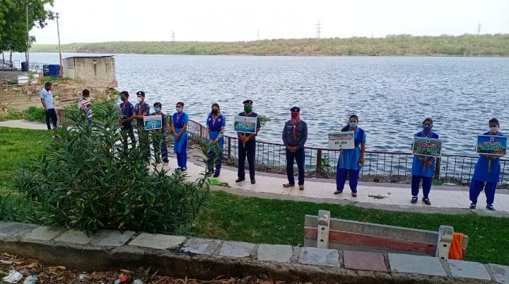 Message of environmental protection given by creating human chain. 