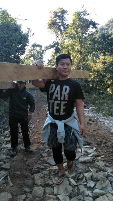 Nachung scout boys transporting wood.