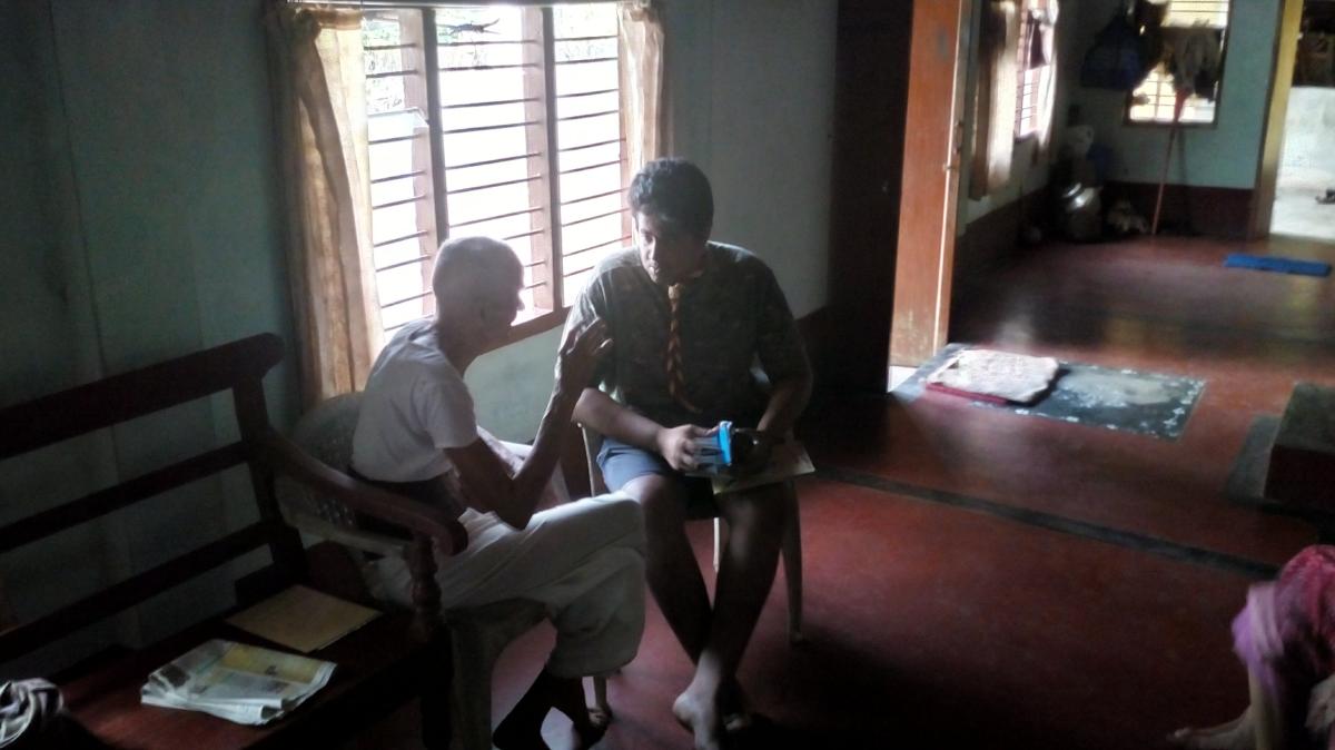 giving medicine to old man