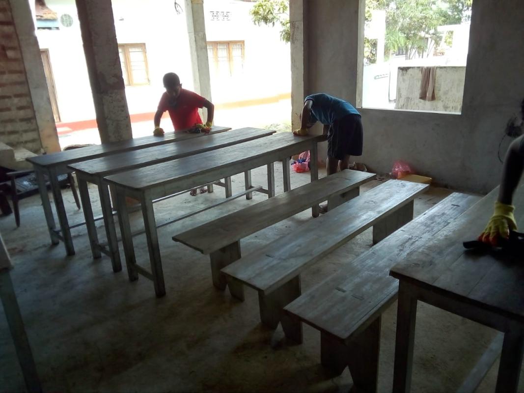 Refurbishing the Alms giving tables and benches polishing the Dhamma school chairs