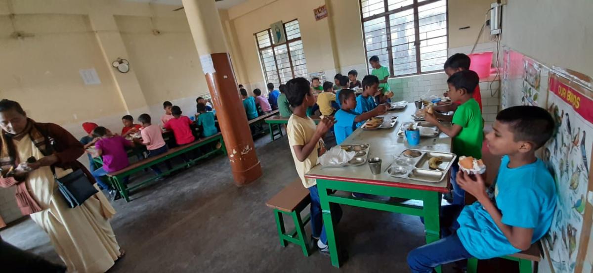 Sunday Morning at the Orphanage distributing food .