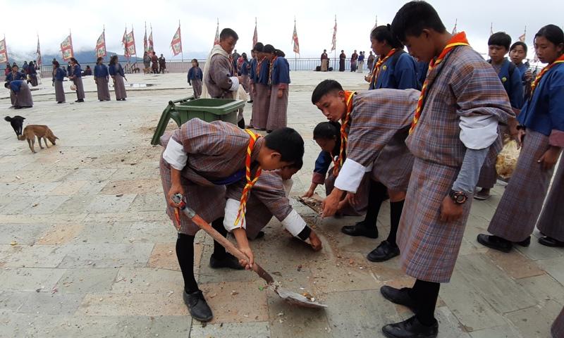 sweeping the ground of Chador Lhakhang