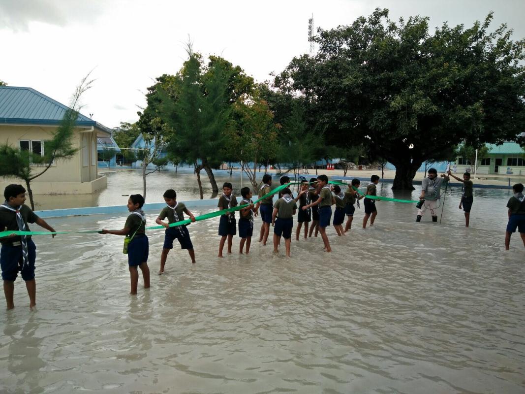 Scouts assisted to drain rain flood in school