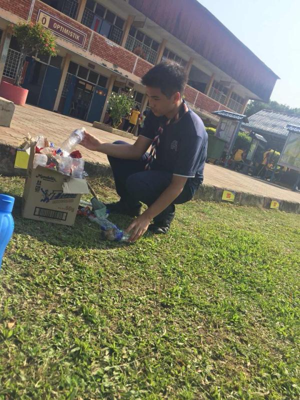 Helping to collect rubbish during the school cross country event