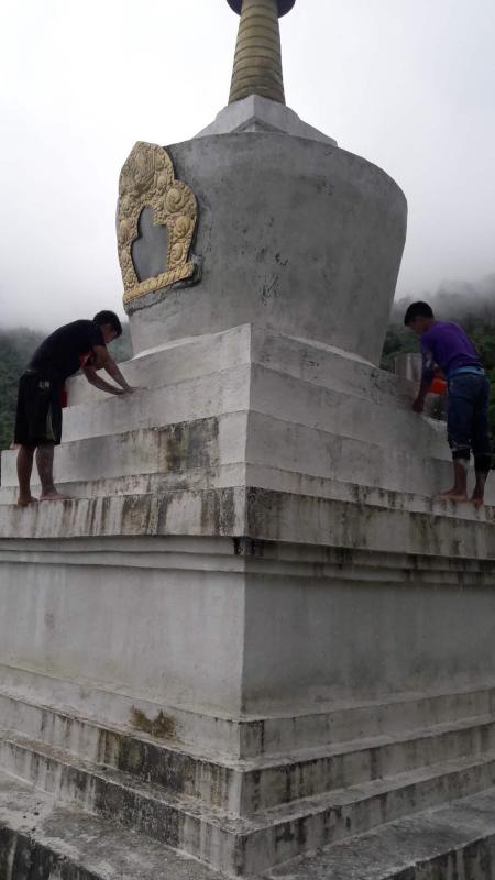 White washed a chorten (stupa).
