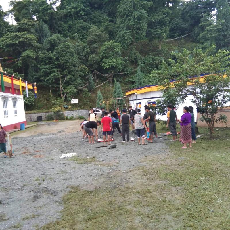 Helping hand in preparation of puja to held in monastery