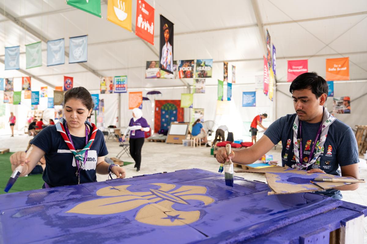 Scouts painting a sign