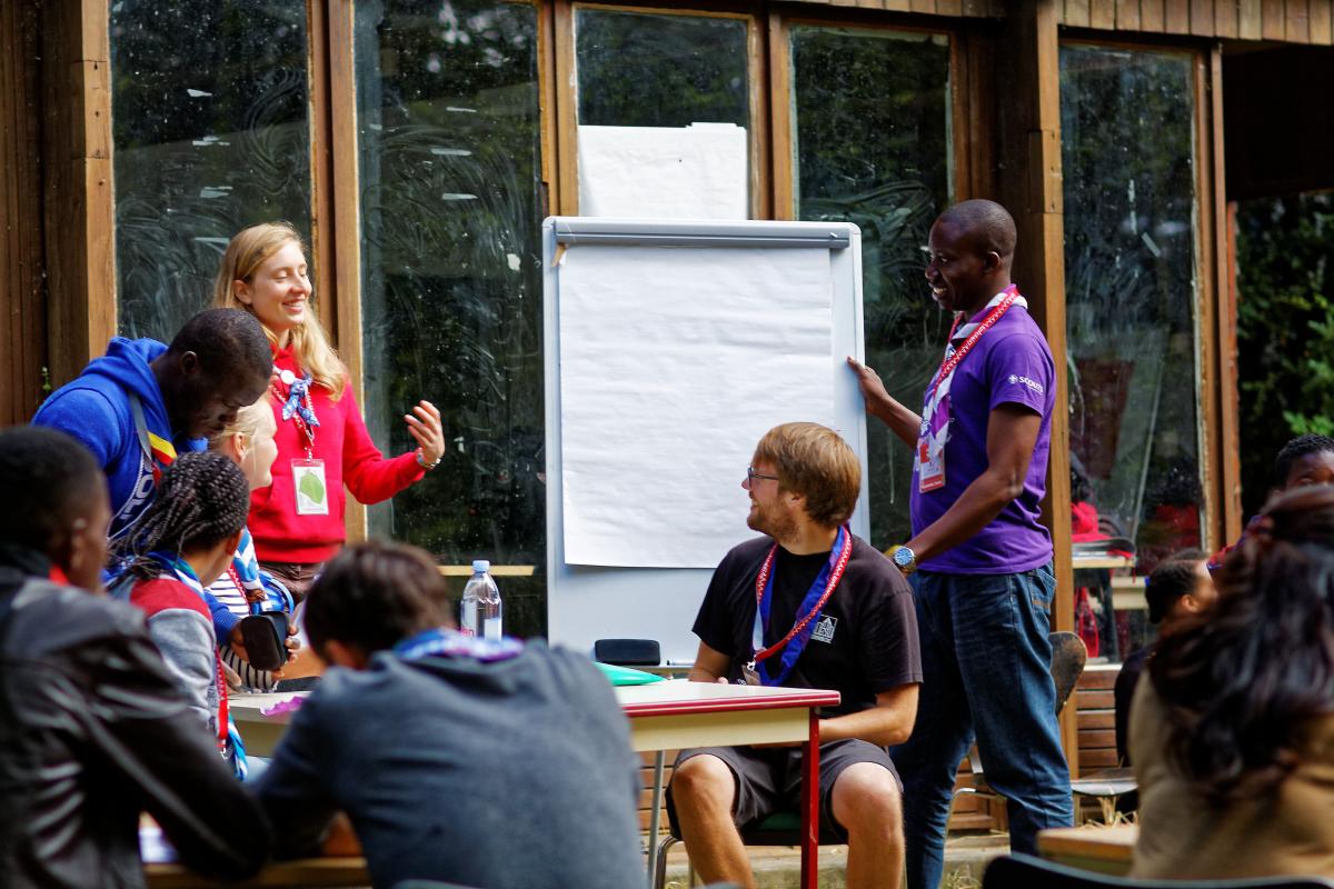 Scouts writing on a flip chart