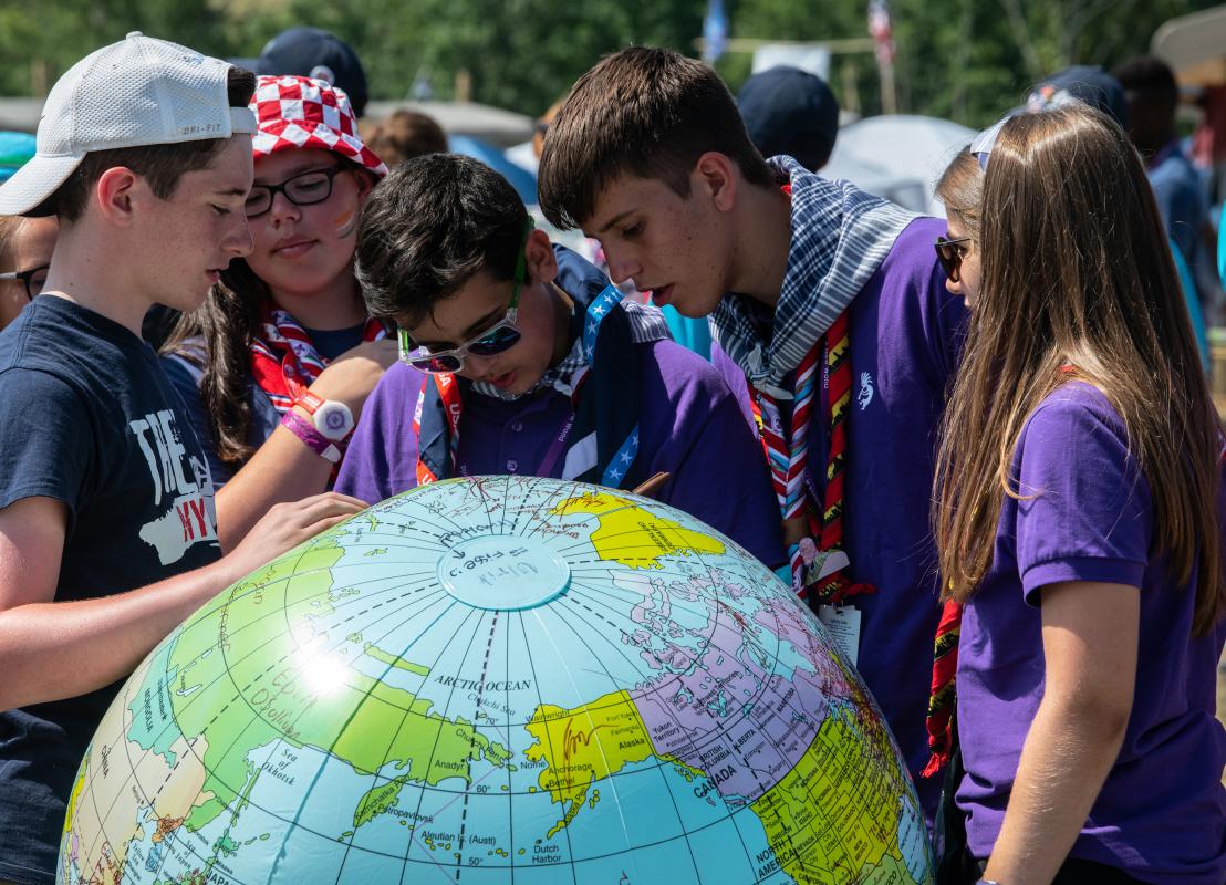 Scouts looking at a globe 