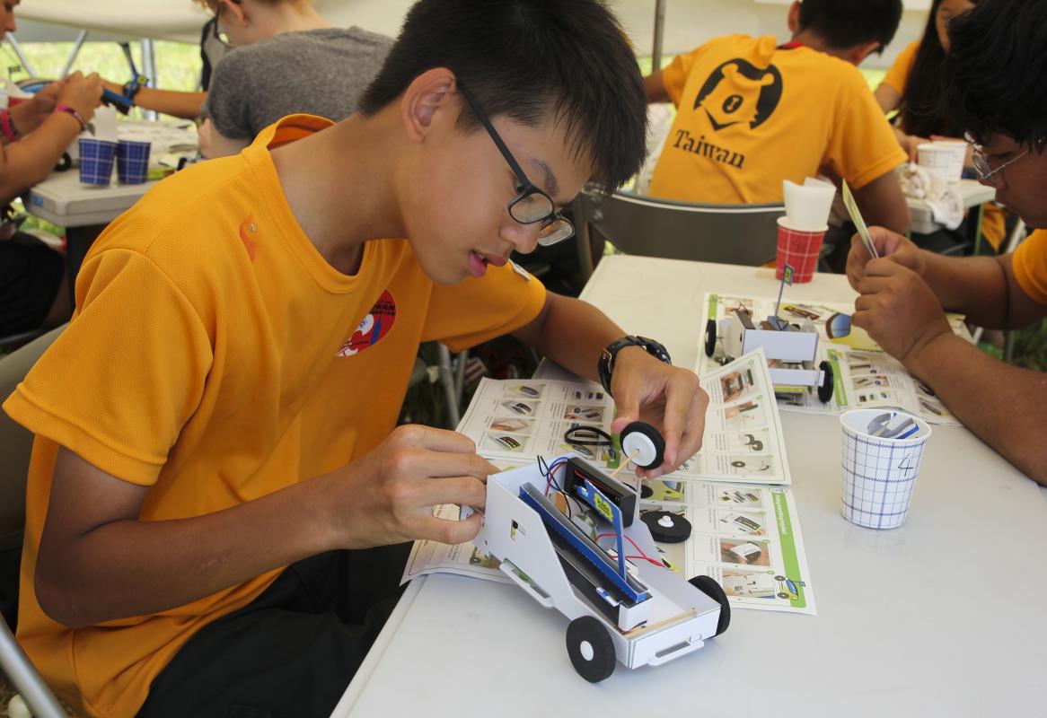A young boy working on experiment