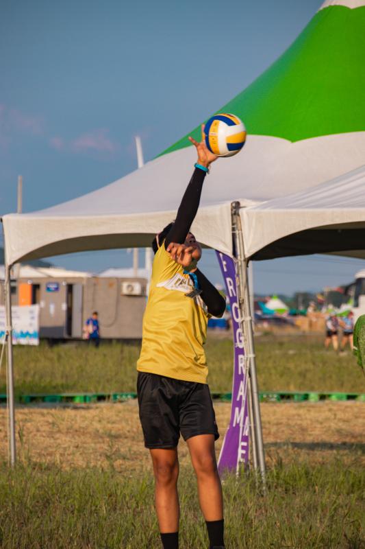 A young person playing volley ball