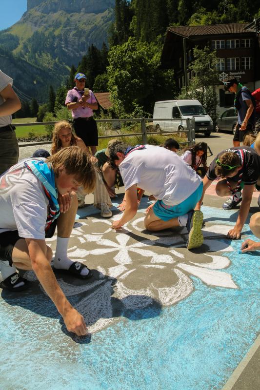 Young people working on a floor art