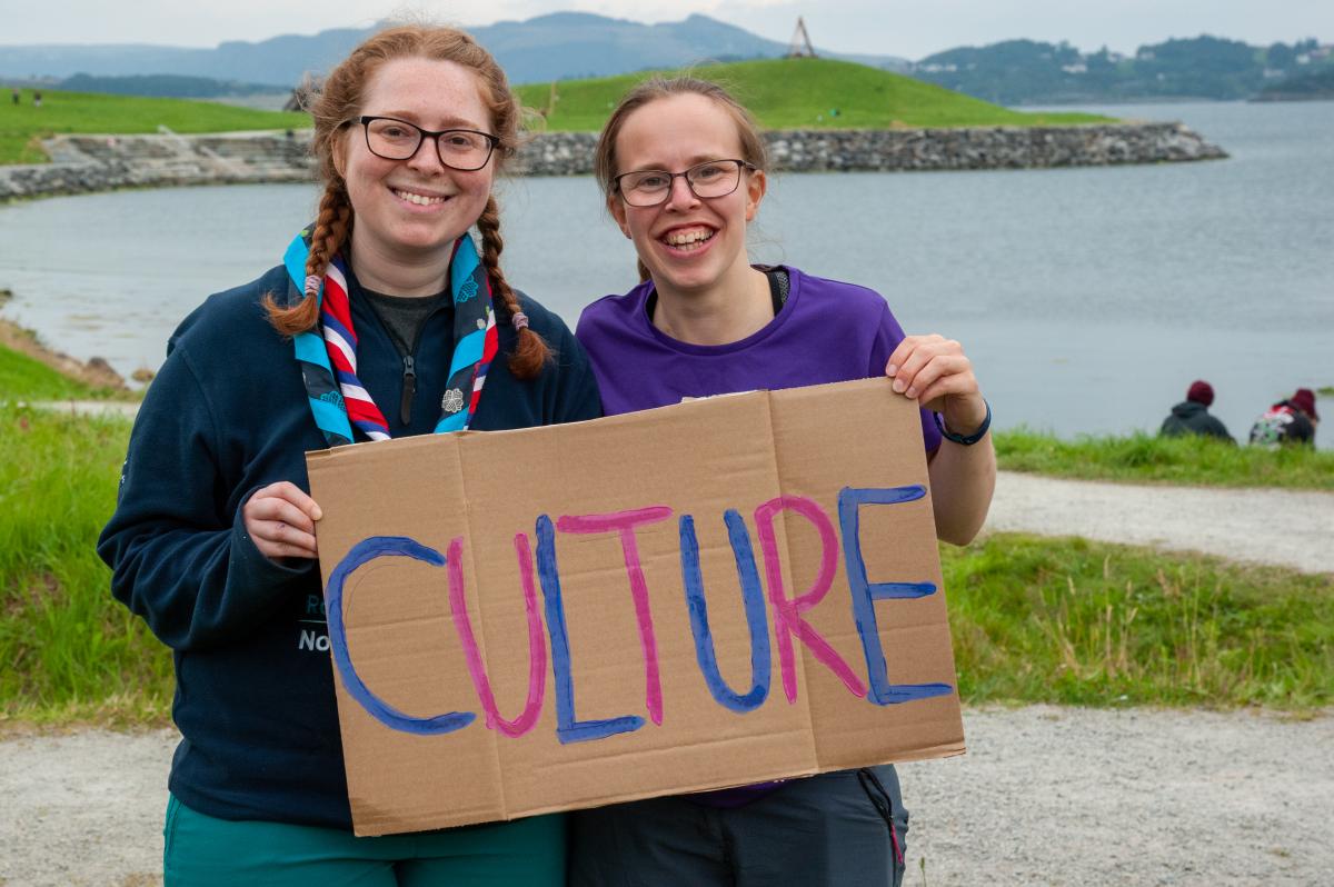 Young people holding a sign