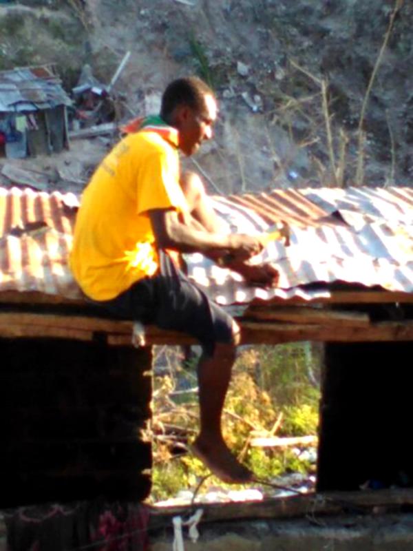 A young person fixing a roof 