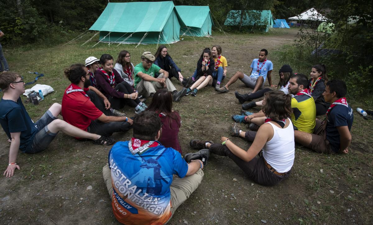 Young scouts sitting in a circle 