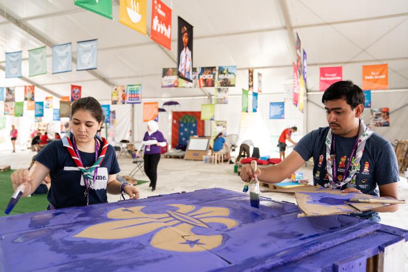 Scouts painting a sign