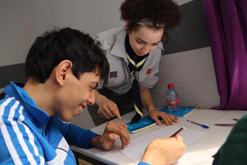 A sscout leader teaching a child