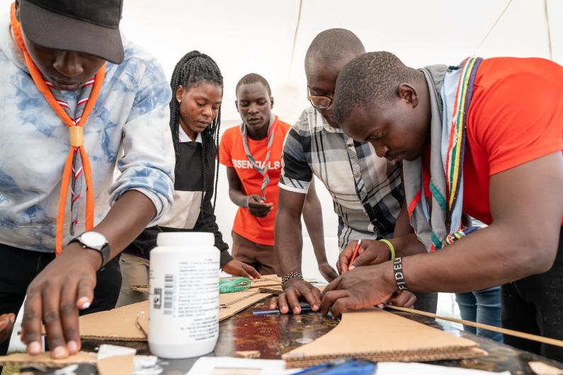 Young people working together to build a tower 