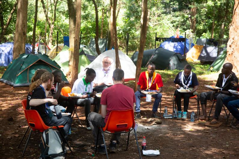 Young people eating in camp sites 