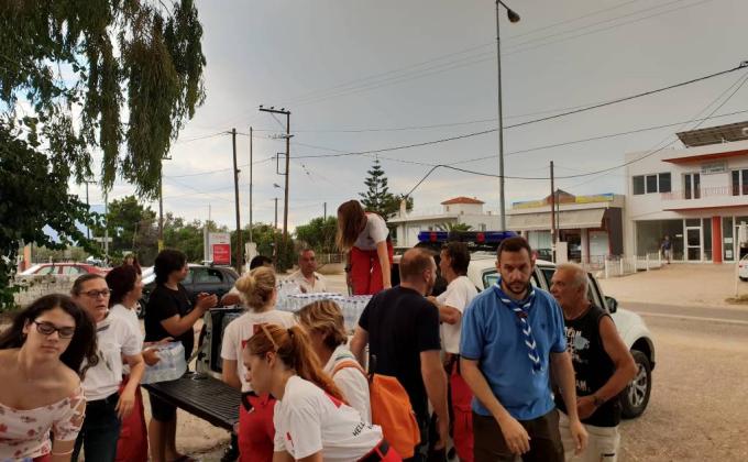 The Scouts of Greece stand by the fire affected