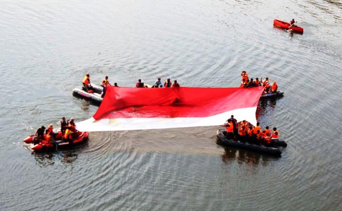 Indonesian Scouts Spread Giant Flag on a Lake