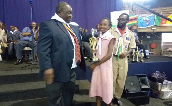 One of our very own scouts from Redcliff Primary School Midlands Province Zimbabwe is awarded for the best art presentation during the Africa Scouts day camp