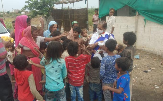 कच्ची  बस्ती  में खाद्य  सामग्री  व फल  वितरित  करते  हुए 